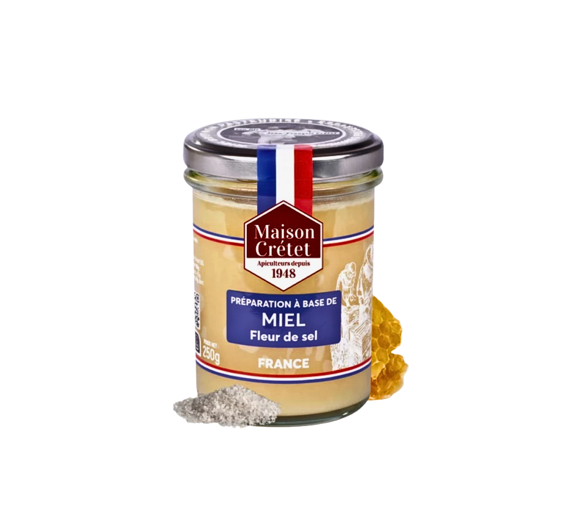 Un pot en verre contenant du miel clair de la marque Maison Crétet . L'étiquette porte la mention « Préparation à base de MIEL Fleur de sel » . Un petit tas de fleur de sel est placé devant le pot, et un rayon de miel est visible sur le côté droit.