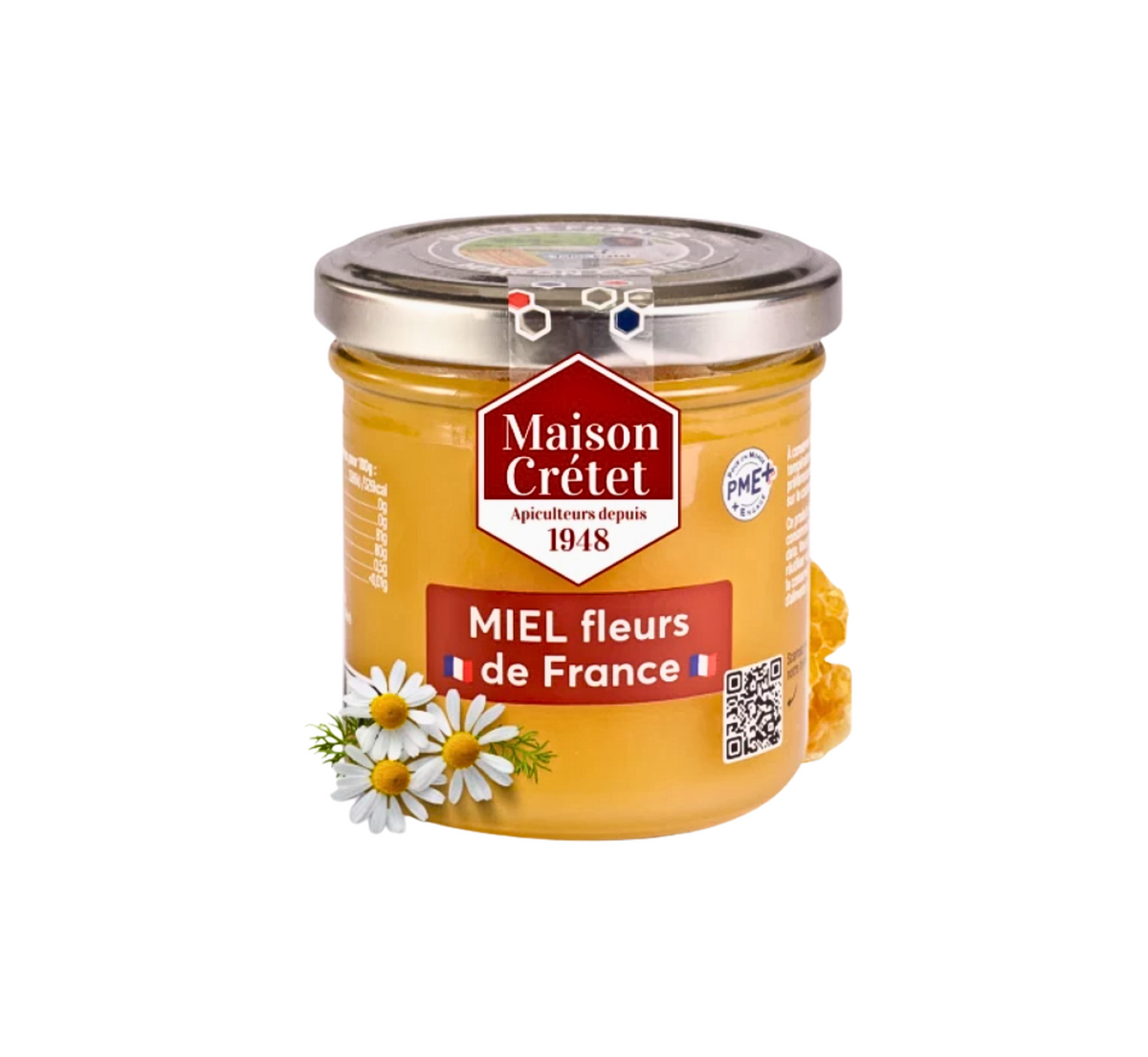 Un pot de miel "fleurs de France" de la marque Maison Crétet, avec des marguerites et un morceau de rayon de miel visible sur le côté, sur un fond blanc